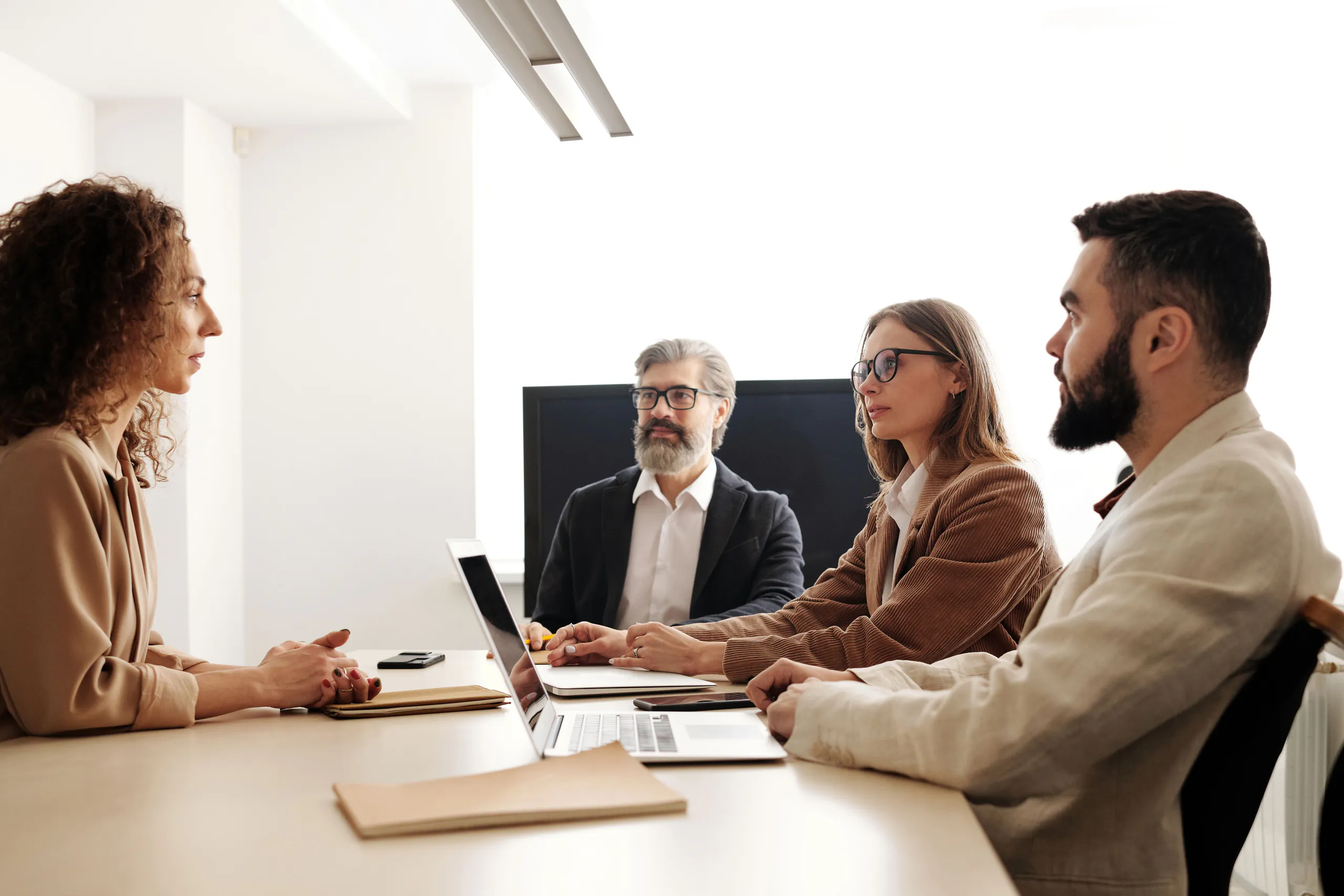 A business team collaborating around a laptop